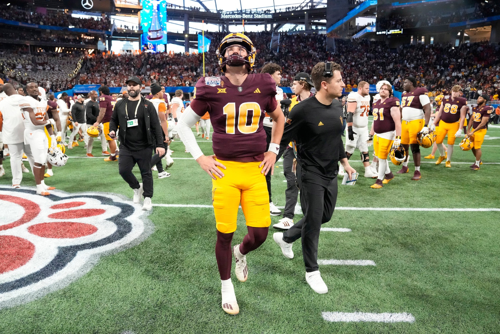 Arizona State quarterback Sam Leavitt (10) walks off the field after Texas won 39-31 over Arizona State in double overtime in the Chick-fil-A Peach Bowl in Atlanta on Wednesday, Jan. 1, 2025. Leavitt is a popular college football futures bet amongst our betting experts.
