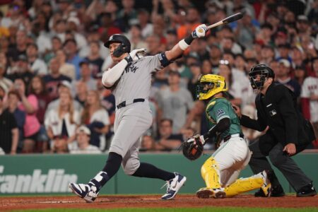 Jun 13, 2025; Boston, Massachusetts, USA; New York Yankees outfielder Aaron Judge (99) hits a home run against the Boston Red Sox in the ninth inning at Fenway Park.