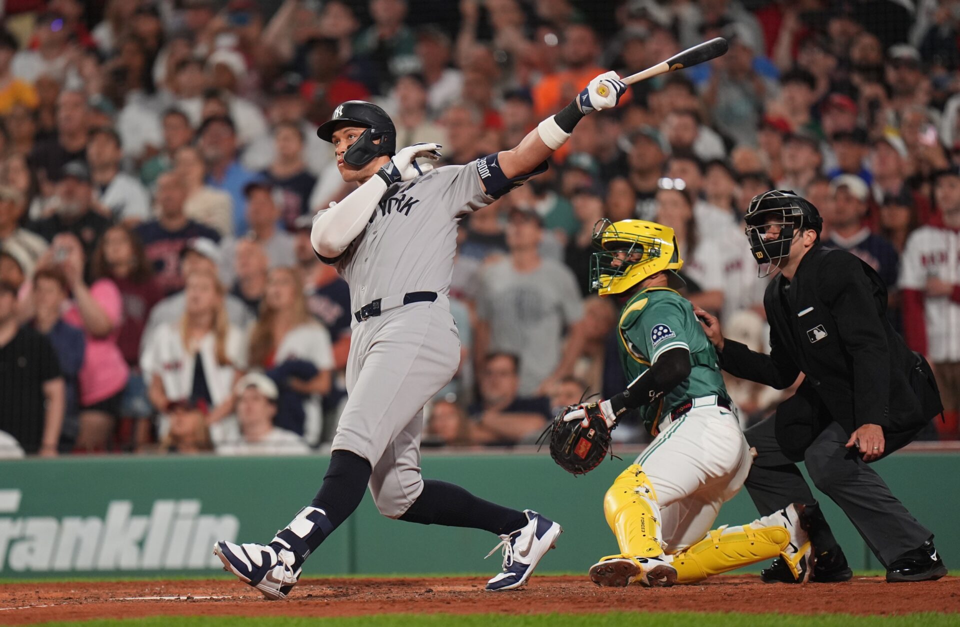 Jun 13, 2025; Boston, Massachusetts, USA; New York Yankees outfielder Aaron Judge (99) hits a home run against the Boston Red Sox in the ninth inning at Fenway Park.