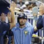 May 17, 2025; Miami, Florida, USA; Tampa Bay Rays second baseman Brandon Lowe (8) is greeted in the dugout by teammates after scoring against the Miami Marlins during the fifth inning at loanDepot Park.