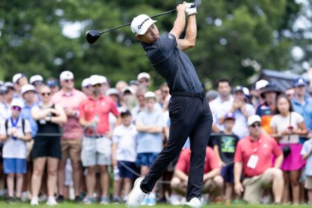 Collin Morikawa plays his shot from the first tee during the first round of the Travelers Championship golf tournament.