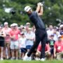 Collin Morikawa plays his shot from the first tee during the first round of the Travelers Championship golf tournament.