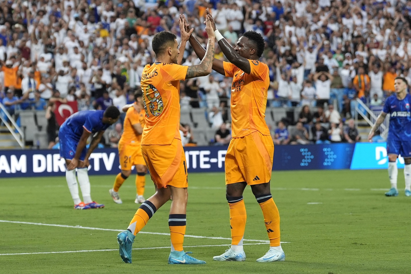 Real Madrid midfielder Dani Ceballos (19) celebrates his goal with forward Rodrygo (11) during the first half against Chelsea at Bank of America Stadium.