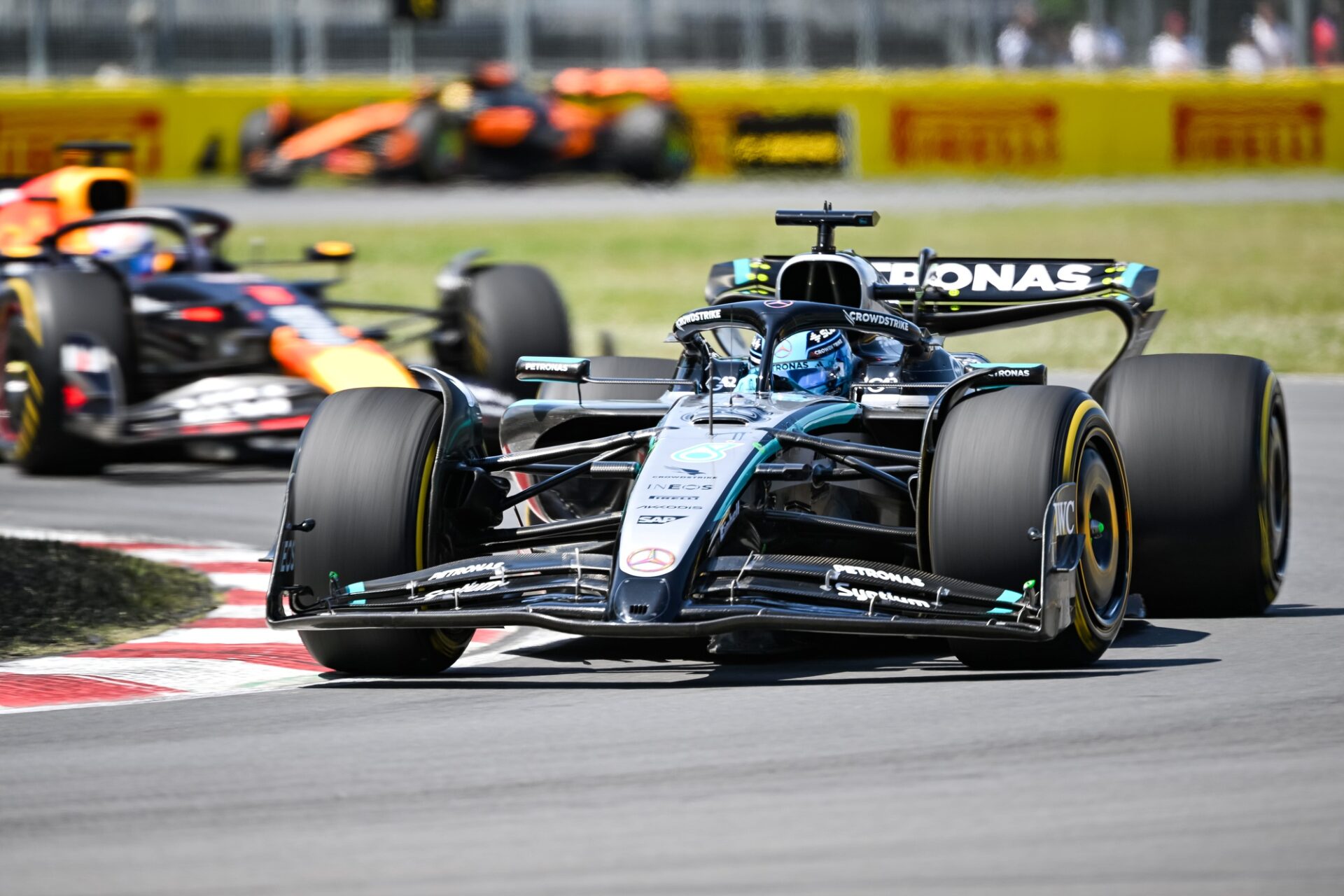Mercedes driver George Russell (63) leads the second lap over Red Bull Racing driver Max Verstappen (1) during the F1 Canadian Grand Prix at Circuit Gilles-Villeneuve.
