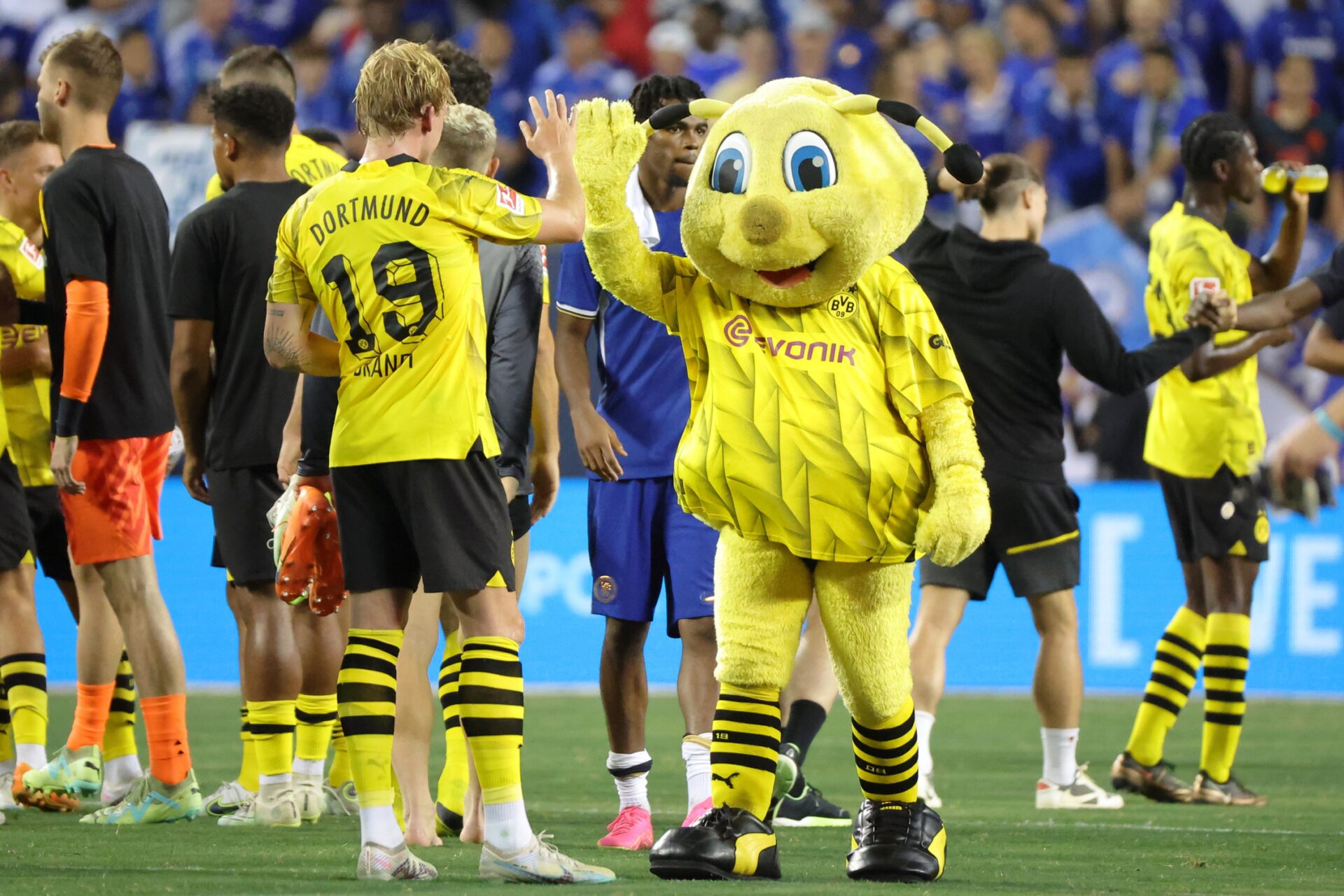 Borussia Dortmund midfielder Julian Brandt (19) high fives mascot Emma after the game against Chelsea at Soldier Field.