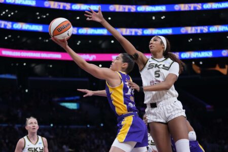 May 25, 2025; Los Angeles, California, USA; LA Sparks guard Kelsey Plum (10) shoots the ball against Chicago Sky forward Angel Reese (5) in the first half at Crypto.com Arena.