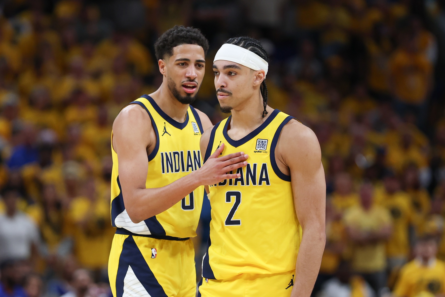 May 31, 2025; Indianapolis, Indiana, USA; Indiana Pacers guard Tyrese Haliburton (0) and guard Andrew Nembhard (2) speak in the second quarter during game six of the eastern conference finals against the New York Knicks for the 2025 NBA Playoffs at Gainbridge Fieldhouse.