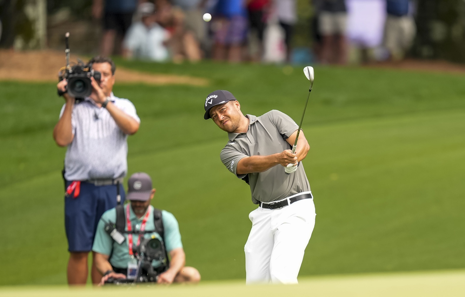 May 16, 2025; Charlotte, North Carolina, USA; Xander Schauffele pitches up to the ninth hole during the second round of the PGA Championship golf tournament at Quail Hollow.
