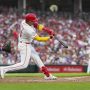 Jul 29, 2025; Cincinnati, Ohio, USA; Cincinnati Reds third baseman Noelvi Marte (16) hits a solo home run against the Los Angeles Dodgers in the fourth inning at Great American Ball Park.