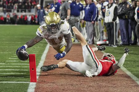 Nov 29, 2024; Athens, Georgia, USA; Georgia Tech Yellow Jackets running back Jamal Haynes (11) scores a touchdown past Georgia Bulldogs defensive back Dan Jackson (17) during the first half at Sanford Stadium.