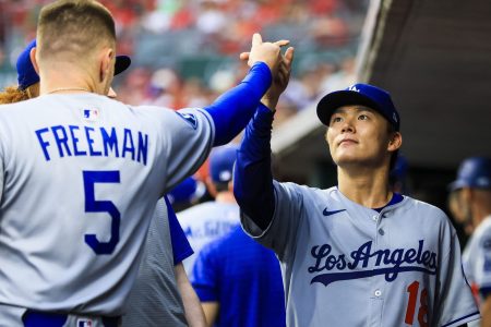 Los Angeles Dodgers starting pitcher Yoshinobu Yamamoto (18) high fives first baseman Freddie Freeman (5) before the game against the Cincinnati Reds at Great American Ball Park.