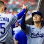 Los Angeles Dodgers starting pitcher Yoshinobu Yamamoto (18) high fives first baseman Freddie Freeman (5) before the game against the Cincinnati Reds at Great American Ball Park.
