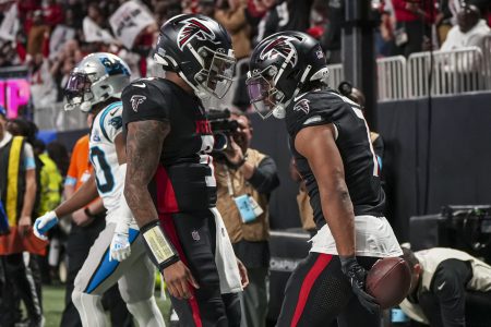 Jan 5, 2025; Atlanta, Georgia, USA; Atlanta Falcons running back Bijan Robinson (7) reacts with quarterback Michael Penix Jr. (9) after running for a touchdown against the Carolina Panthers during the second half at Mercedes-Benz Stadium.