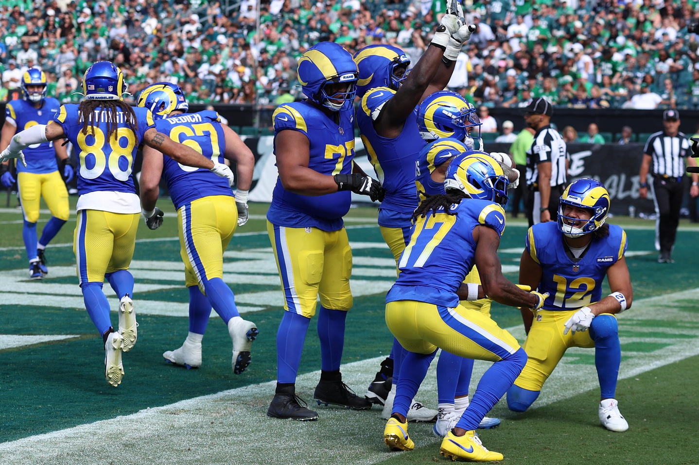 Los Angeles Rams running back Kyren Williams (23) reacts with wide receiver Davante Adams (17) and wide receiver Puka Nacua (12) after a touchdown during the second half at Lincoln Financial Field.