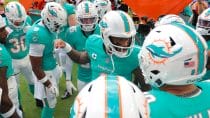 Miami Dolphins quarterback Tua Tagovailoa (1) talks to his teammates before the game against the San Francisco 49ers at Hard Rock Stadium.