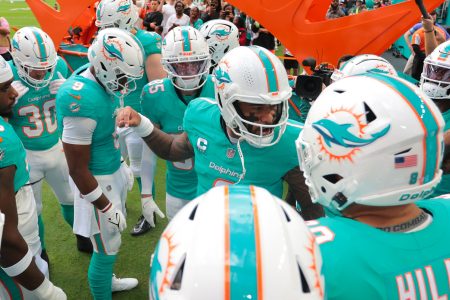 Miami Dolphins quarterback Tua Tagovailoa (1) talks to his teammates before the game against the San Francisco 49ers at Hard Rock Stadium.