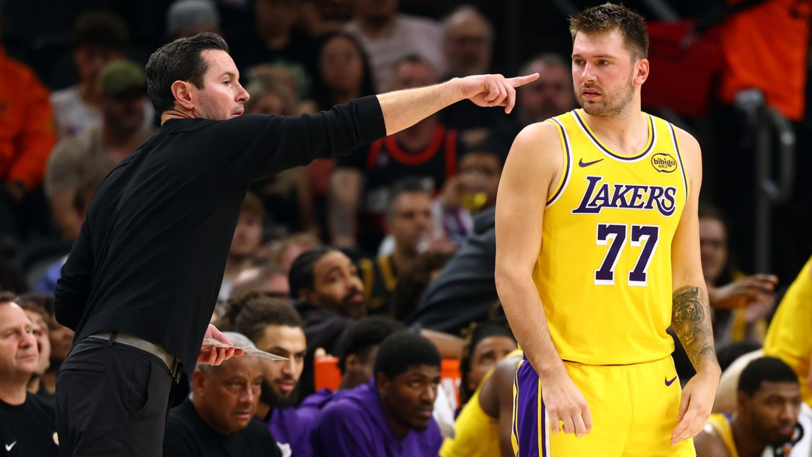 Oct 14, 2025; Phoenix, Arizona, USA; Los Angeles Lakers guard Luka Doncic (77) with head coach JJ Redick against the Phoenix Suns during an NBA preseason game at Mortgage Matchup Center.