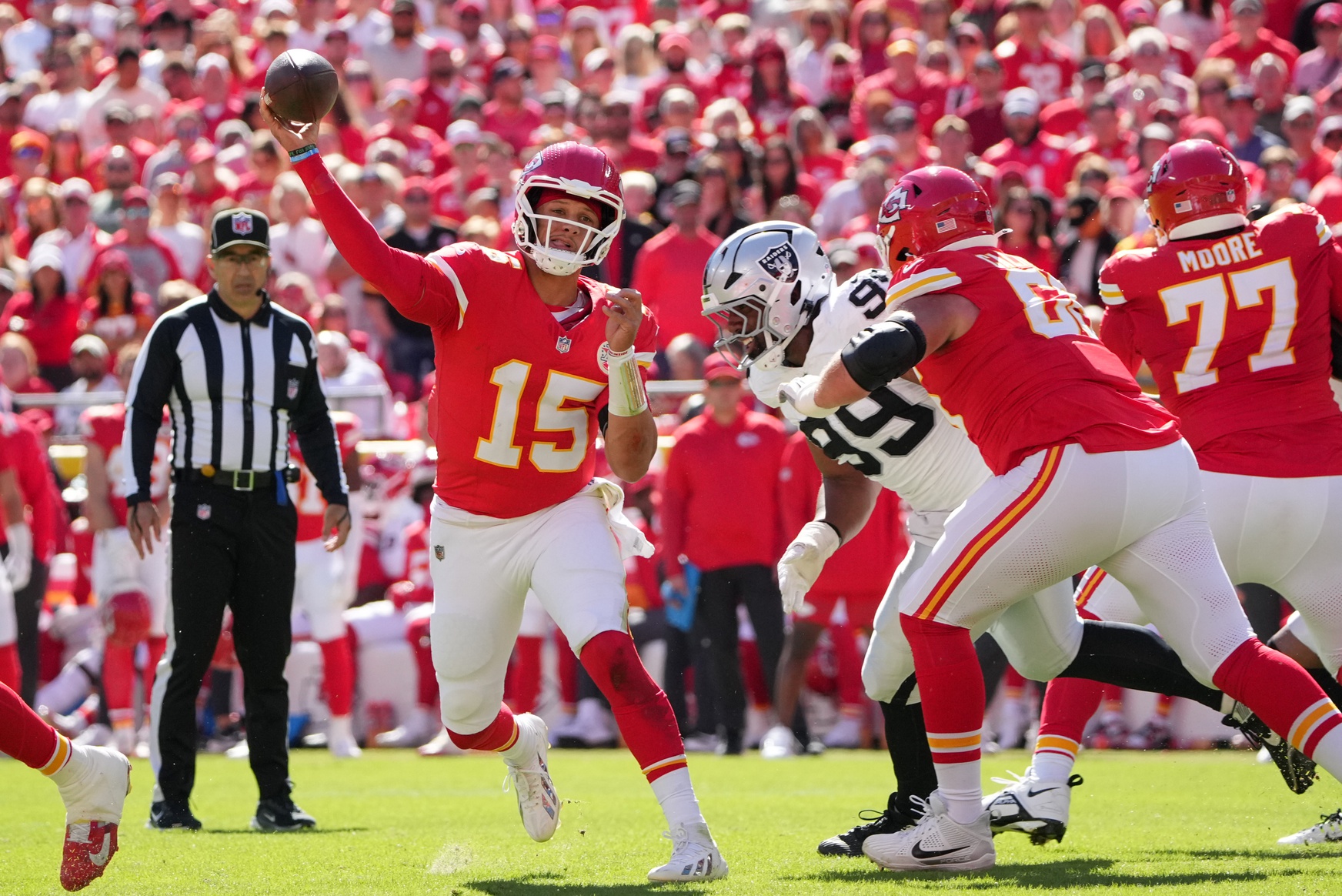 Oct 19, 2025; Kansas City, Missouri, USA; Kansas City Chiefs quarterback Patrick Mahomes (15) passes the ball against the Las Vegas Raiders during the second quarter of the game at GEHA Field at Arrowhead Stadium.