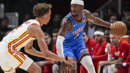 Oct 25, 2025; Atlanta, Georgia, USA; Oklahoma City Thunder guard Shai Gilgeous-Alexander (2) controls the ball against Atlanta Hawks guard Dyson Daniels (5) during the first half at State Farm Arena.