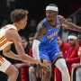 Oct 25, 2025; Atlanta, Georgia, USA; Oklahoma City Thunder guard Shai Gilgeous-Alexander (2) controls the ball against Atlanta Hawks guard Dyson Daniels (5) during the first half at State Farm Arena.