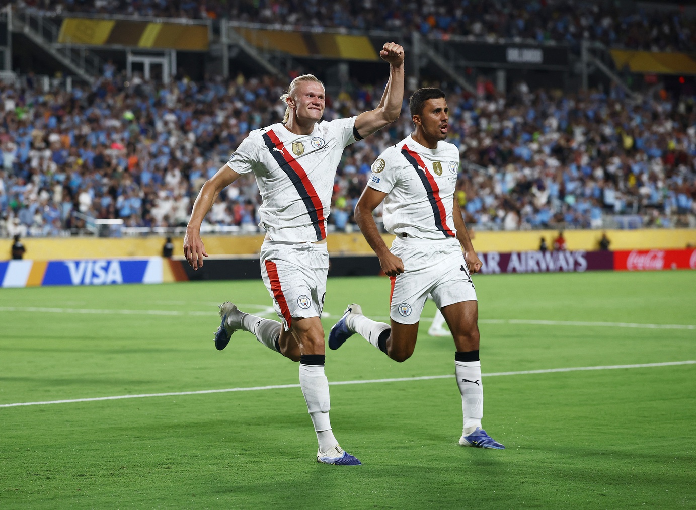 Manchester City forward Erling Haaland (9) celebrates scoring their second goal with midfielder Rodri (16) during a round of 16 match of the 2025 FIFA Club World Cup at Camping World Stadium.