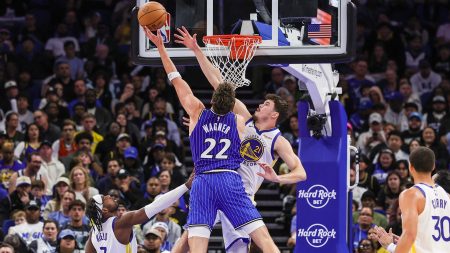 Nov 18, 2025; Orlando, Florida, USA; Orlando Magic forward Franz Wagner (22) goes to the basket against Golden State Warriors center Quinten Post (21) during the second half at Kia Center.