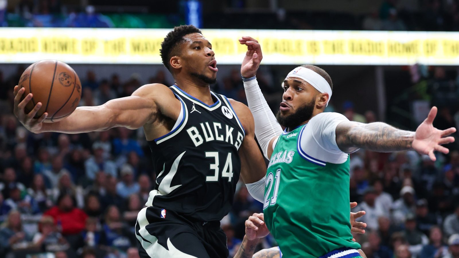 Nov 10, 2025; Dallas, Texas, USA; Milwaukee Bucks forward Giannis Antetokounmpo (34) looks to pass around Dallas Mavericks forward Daniel Gafford (21) during the first quarter at American Airlines Center.
