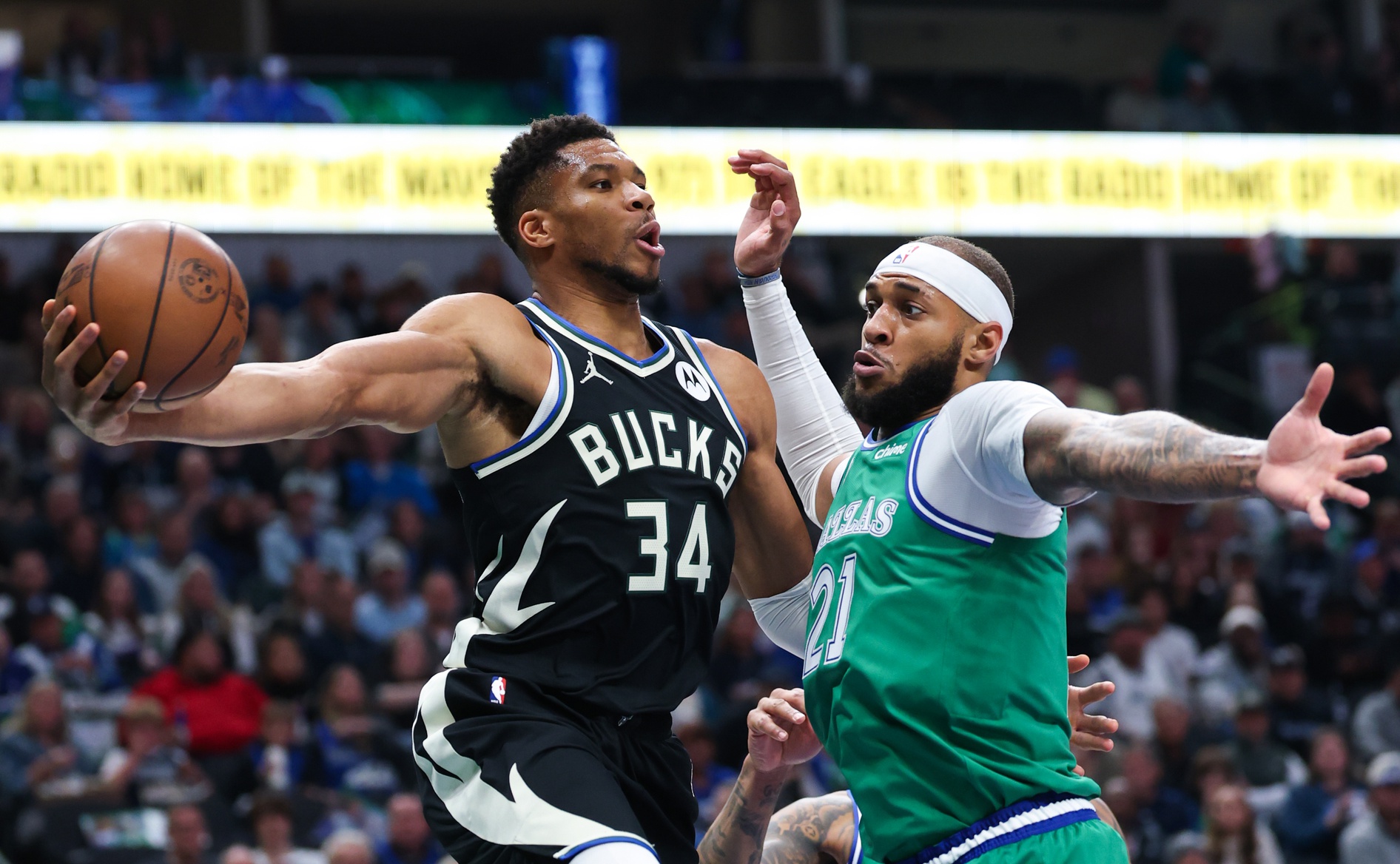 Nov 10, 2025; Dallas, Texas, USA; Milwaukee Bucks forward Giannis Antetokounmpo (34) looks to pass around Dallas Mavericks forward Daniel Gafford (21) during the first quarter at American Airlines Center.