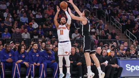 Nov 9, 2025; New York, New York, USA; New York Knicks guard Jalen Brunson (11) takes a three point shot past Brooklyn Nets guard Egor Demin (8) in the first quarter at Madison Square Garden.