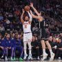 Nov 9, 2025; New York, New York, USA; New York Knicks guard Jalen Brunson (11) takes a three point shot past Brooklyn Nets guard Egor Demin (8) in the first quarter at Madison Square Garden.