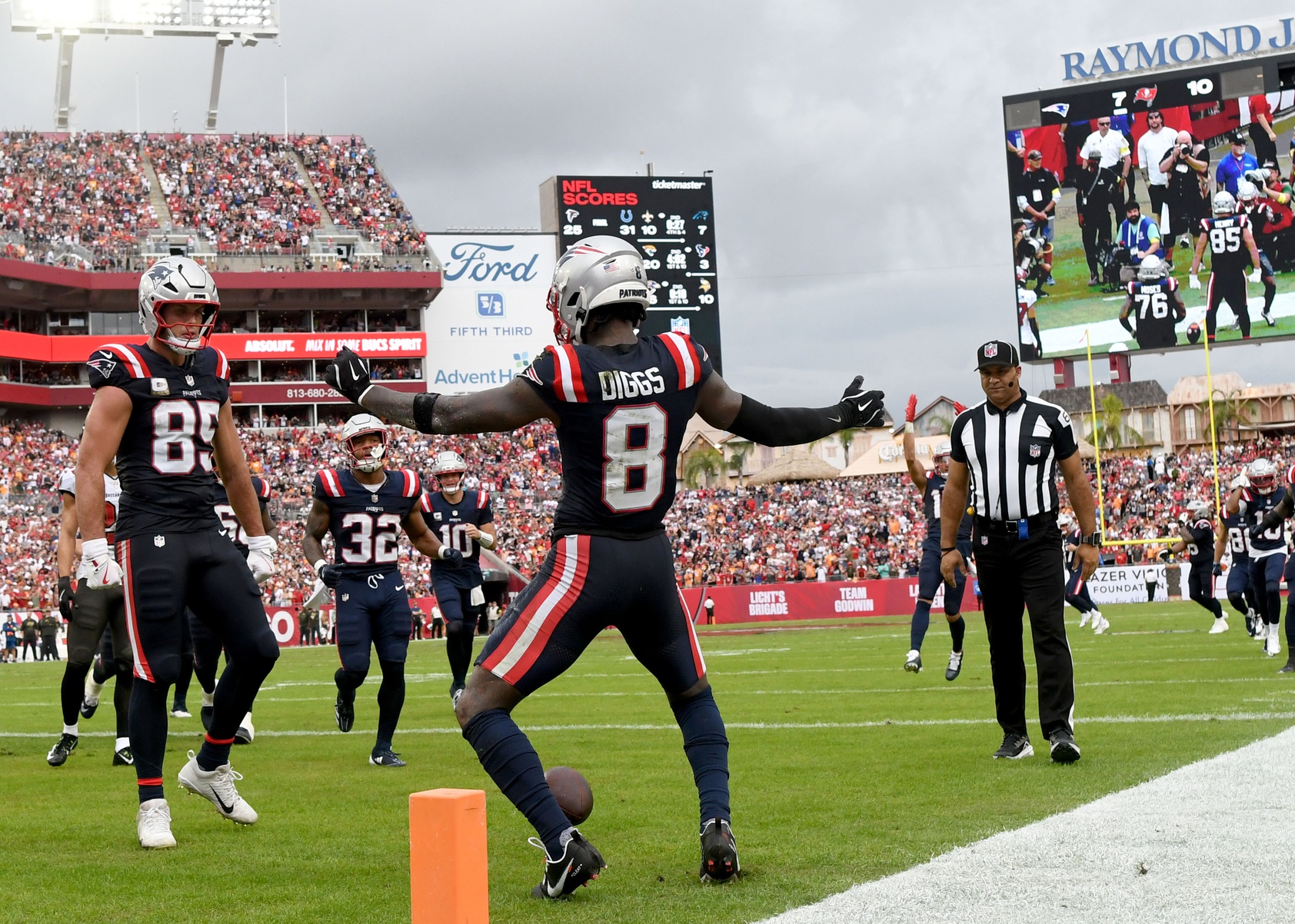 Nov 9, 2025; Tampa, Florida, USA; New England Patriots wide receiver Stefon Diggs (8) celebrates a touchdown with tight end Hunter Henry (85) during the second quarter against the Tampa Bay Buccaneers at Raymond James Stadium.