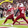 Oct 19, 2025; Glendale, Arizona, USA; Arizona Cardinals tight end Trey McBride (85) spikes the ball as he celebrates a touchdown with teammate Greg Dortch (4) against the Green Bay Packers in the second half at State Farm Stadium.