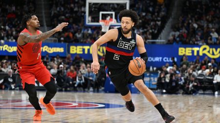 Dec 5, 2025; Detroit, Michigan, USA; Detroit Pistons guard Cade Cunningham (2) drives to the basket past Portland Trail Blazers guard Caleb Love (2) in the second quarter at Little Caesars Arena.