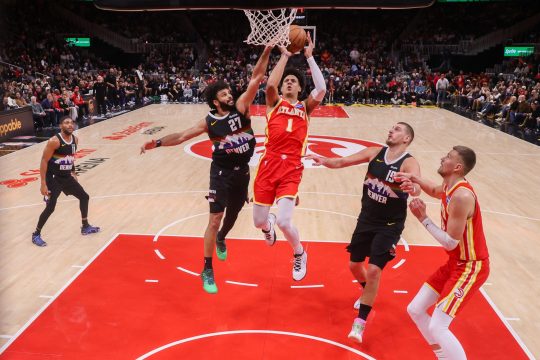 Dec 5, 2025; Atlanta, Georgia, USA; Atlanta Hawks forward Jalen Johnson (1) shoots past Denver Nuggets guard Jamal Murray (27) in the fourth quarter at State Farm Arena.