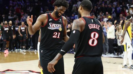 Dec 12, 2025; Philadelphia, Pennsylvania, USA; Philadelphia 76ers center Joel Embiid (21) reacts with forward Paul George (8) after a victoryagainst the Indiana Pacers during at Xfinity Mobile Arena.