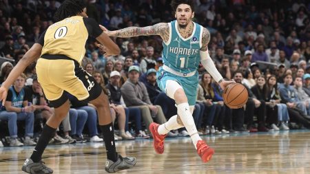 Dec 23, 2025; Charlotte, North Carolina, USA; Charlotte Hornets guard LaMelo Ball (1) drives past Washington Wizards forward Bilal Coulibaly (0) during the second half at the Spectrum Center.