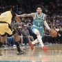 Dec 23, 2025; Charlotte, North Carolina, USA; Charlotte Hornets guard LaMelo Ball (1) drives past Washington Wizards forward Bilal Coulibaly (0) during the second half at the Spectrum Center.