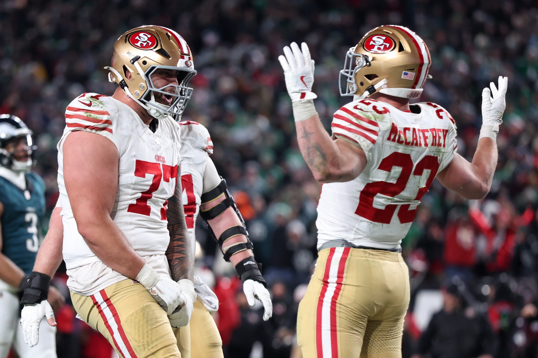 Jan 11, 2026; Philadelphia, PA, USA; San Francisco 49ers running back Christian McCaffrey (23) celebrates after scoring a touchdown against the Philadelphia Eagles with San Francisco 49ers guard Dominick Puni (77) during the fourth quarter in an NFC Wild Card Round game at Lincoln Financial Field.