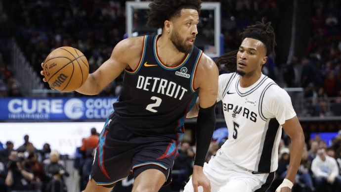 Feb 23, 2026; Detroit, Michigan, USA; Detroit Pistons guard Cade Cunningham (2) dribbles on San Antonio Spurs guard Stephon Castle (5) in the second half at Little Caesars Arena.