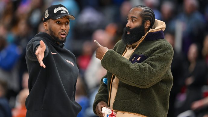Feb 27, 2026; Detroit, Michigan, USA; Cleveland Cavaliers guard Donovan Mitchell (left) talks with teammate James Harden during a timeout against the Detroit Pistons in the second half at Little Caesars Arena. Neither played in their overtime loss to the Pistons.