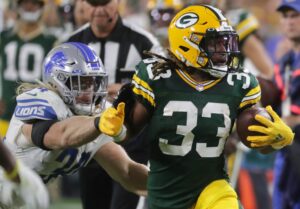 Green Bay Packers running back Aaron Jones runs with the ball vs the Detroit Lions