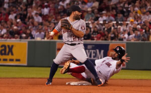 Houston Astros second baseman Jose Altuve forces out Boston Red Sox shortstop Xander Bogarts at second base