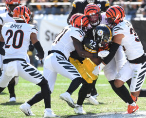 The Cincinnati Bengals defense swarms PITTSBURGH STEELERS running back Najee Harris on a tackle