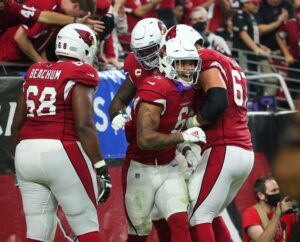 Arizona Cardinals running back James Conner (number 6) celebrates with teammates after a touchdown run against the Houston Texans