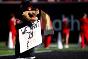 The Cincinnati Bearcats mascot holds a sign in the second half of the NCAA football game 