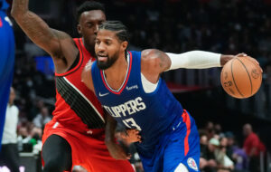 Los Angeles Clippers guard Paul George drives to the basket past Portland Trail Blazers guard Anfernee Simons