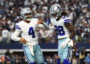 Dallas Cowboys quarterback Dak Prescott and wide receiver CeeDee Lamb celebrate after scoring a touchdown