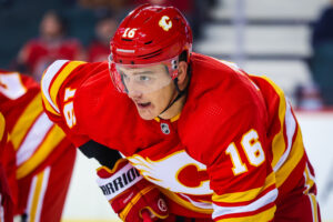 Calgary Flames defenseman Nikita Zadorov prepares to take a face-off in a preseason game