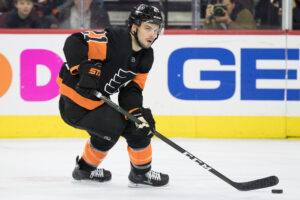 Philadelphia Flyers center Scott Laughton stakes with the puck on his stick