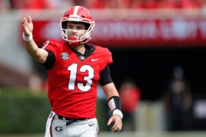 Georgia quarterback Stetson Bennett, wearing a number 13 jersey, signals a first down